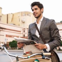 business-man-holding-newspaper-on-a-bicycle-2021-08-29-02-45-35-utc.jpg